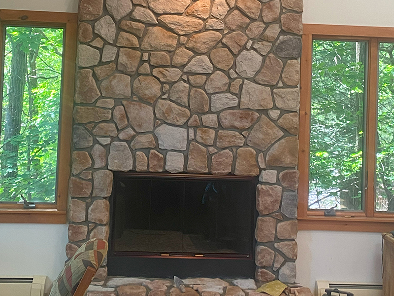 Indoor stone chimney and fireplace