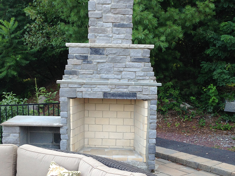Outdoor stone fireplace with seating